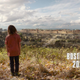 A boy looks out over a ravaged city with the words Boston 2023 displayed onscreen in a scene from HBO's The Last of Us.